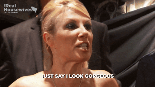a woman says just say i look gorgeous in front of a real housewives sign