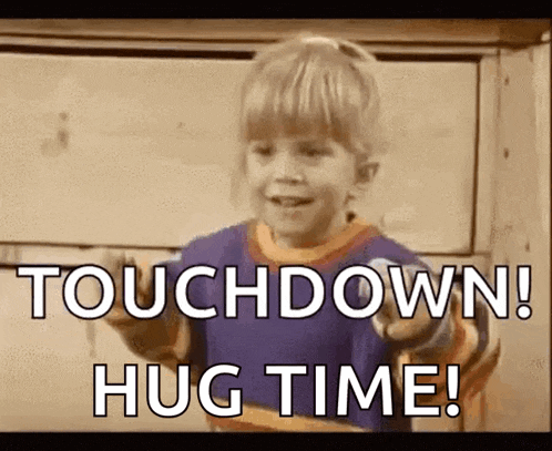 a young boy says touchdown hug time in front of a wall