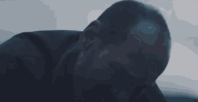 a close up of a man 's face with a dark background