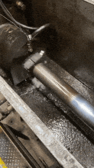 a metal pipe is being worked on in a factory