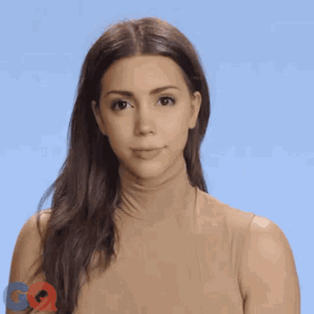 a woman with a ring on her finger is making a middle finger gesture .