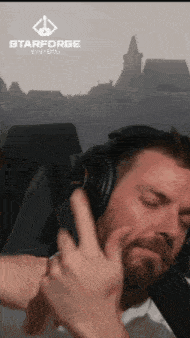 a man wearing headphones with a starforge logo on the bottom