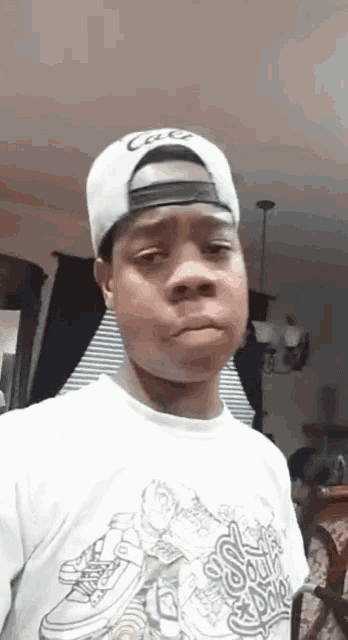 a young man wearing a hat and a t-shirt that says ' socks & shoes ' on it