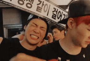 a man with red hair is making a funny face in front of a sign that says ' a ' on it .