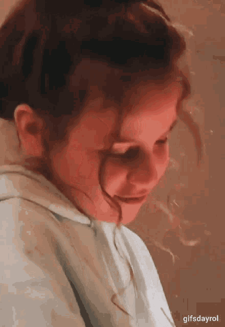 a close up of a little girl 's face with the words gifsdayrol written below it