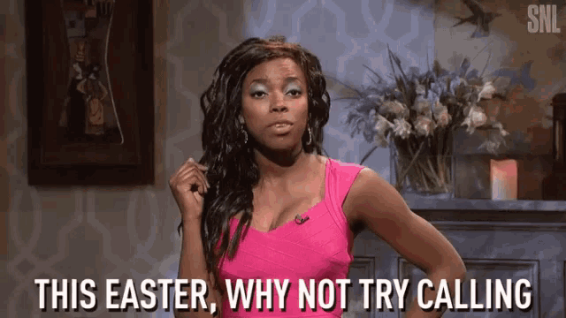 a woman in a pink top is standing in front of a fireplace and says this easter , why not try calling .