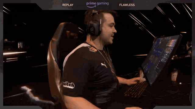 a man wearing headphones is sitting in front of a computer screen that says prime gaming replay flawless and twitch