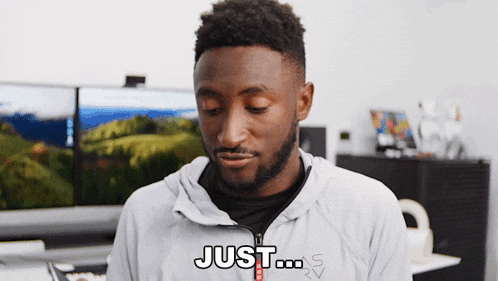 a man with a beard is wearing a jacket that says just on it