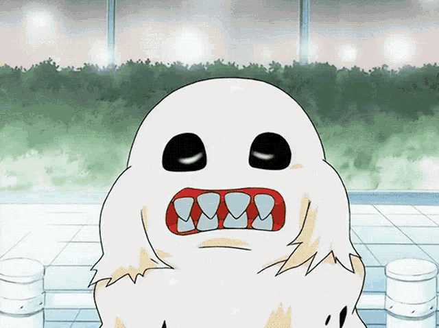 a cartoon drawing of a ghost with big teeth and black eyes