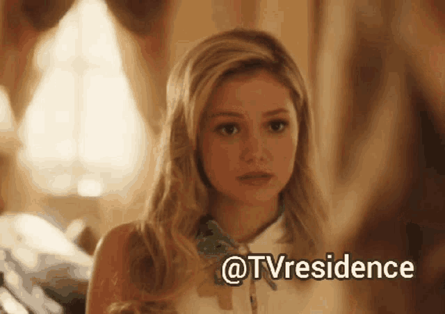 a woman is looking at herself in a mirror and the words @tvresidence are above her
