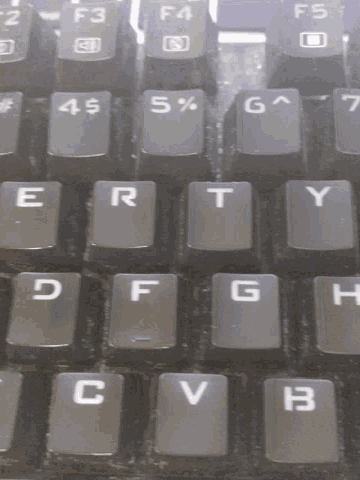 a close up of a keyboard with the letters e r t g h b and v visible