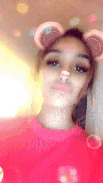 a woman wearing a snapchat filter with bear ears