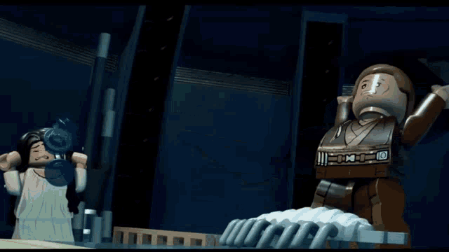 a lego character stands in front of a large gray object