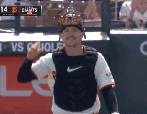 a catcher giving a thumbs up during a game against the giants
