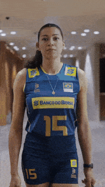 a woman wearing a banco do brasil jersey