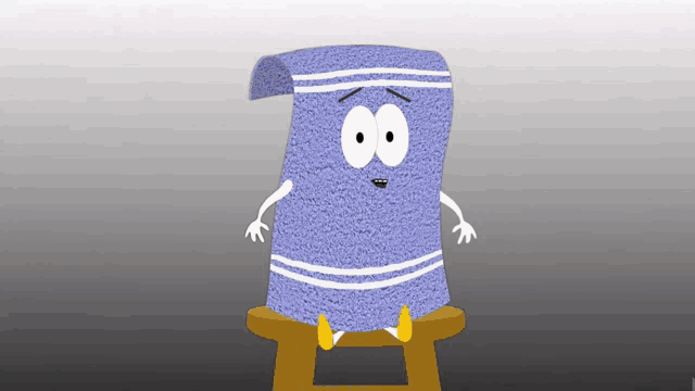 a blue towel with arms and legs sits on a stool