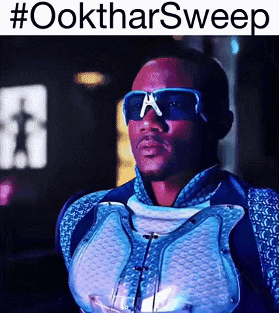 a man wearing sunglasses and a mask with the hashtag #ooktharsweep above him