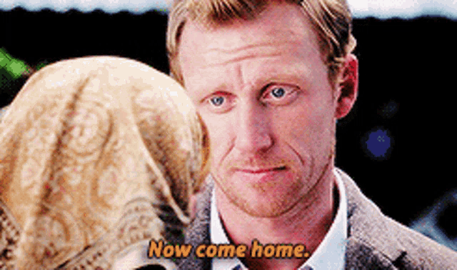 a man with a beard is talking to a woman and says now come home .