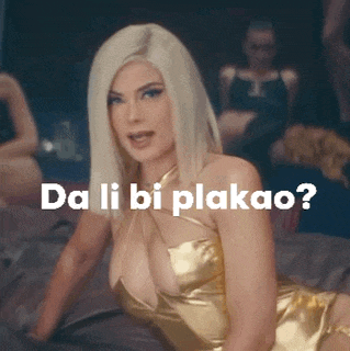 a woman in a gold dress is laying on a bed with the words da li bi plakao written on the bottom