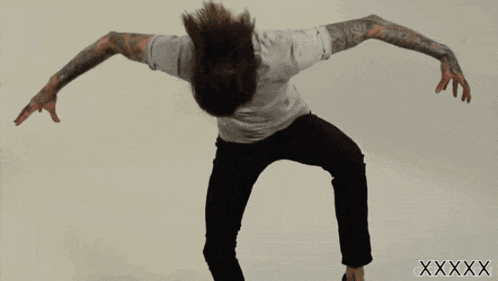 a man in a white shirt and black pants is dancing in front of a white background with the letters xxxxxxxxxxx on it