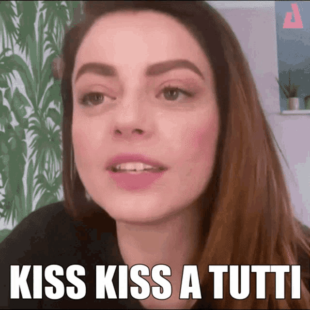 a close up of a woman 's face with the words kiss kiss a tutti on the bottom