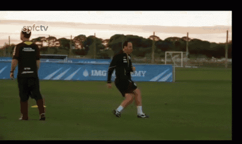 a soccer player kicks a ball in front of a banner that says spfctv