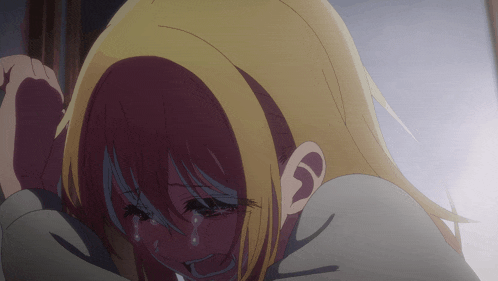 a girl with blonde hair is crying and covering her face