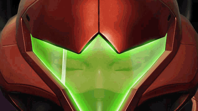 a close up of a video game character 's helmet with a green light on it