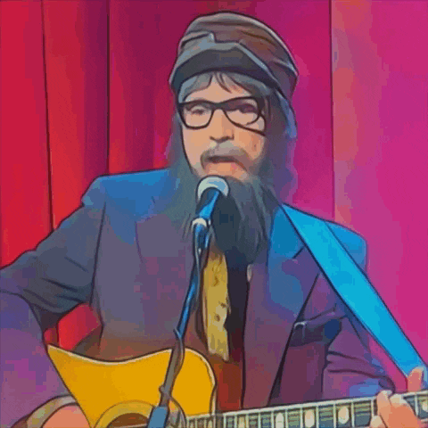 a man with glasses and a beard is singing into a microphone while playing a guitar