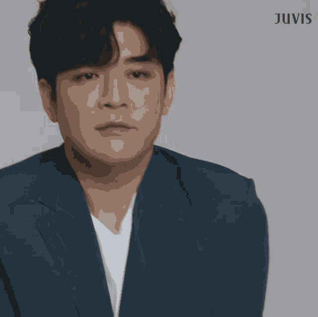a man in a blue suit and white t-shirt with juvis written on the bottom
