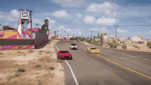 cars are driving down a road with a sign that says h