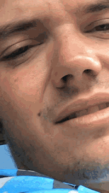 a closeup of a man 's face with his eyes closed