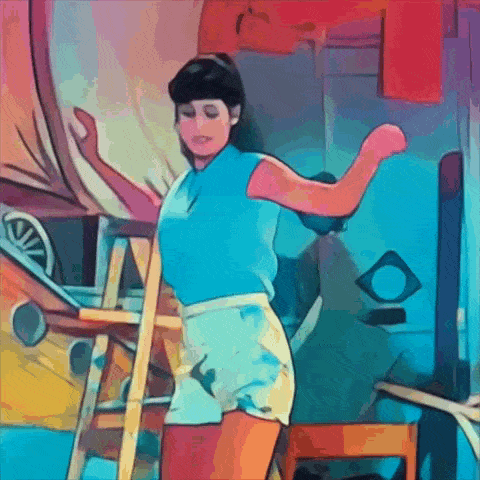 a woman in a blue shirt and white shorts is standing next to a wooden ladder .