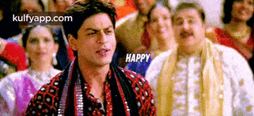 a man is standing in front of a crowd of people and says `` happy '' .