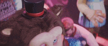 a close up of a doll wearing a top hat