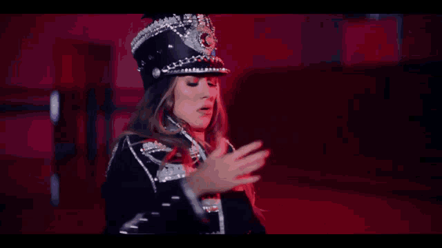 a woman wearing a hat with the letter c on it is dancing