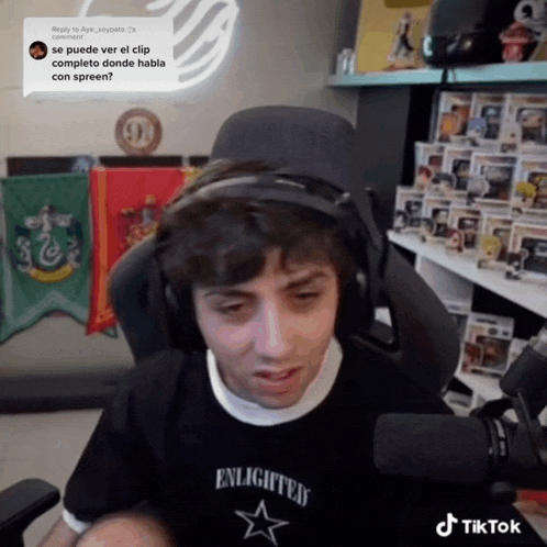 a man wearing headphones and a shirt that says enlightened star