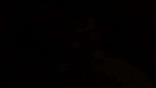 a man without a shirt is standing in a room in a video game and looking at the camera .