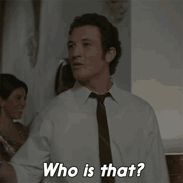 a man in a white shirt and tie asks who is that