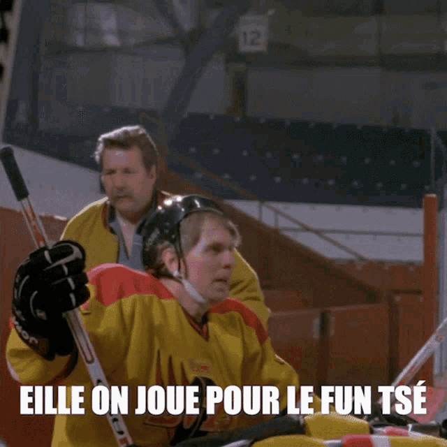 a hockey player wearing a yellow jersey that says boys on it
