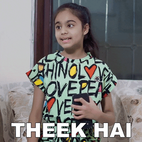 a little girl is holding a cell phone with the words theek hai written below her