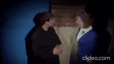 a man and a woman are standing next to each other in front of a door .