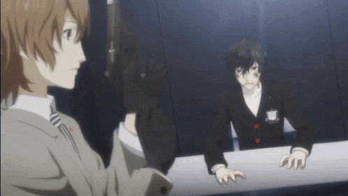 a man in a suit is holding a gun while another man looks on