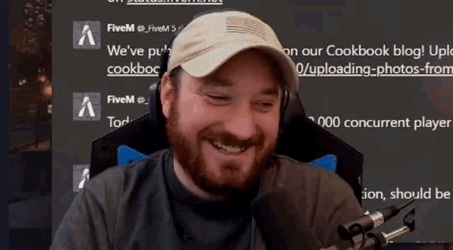 a man with a beard is sitting in front of a microphone .