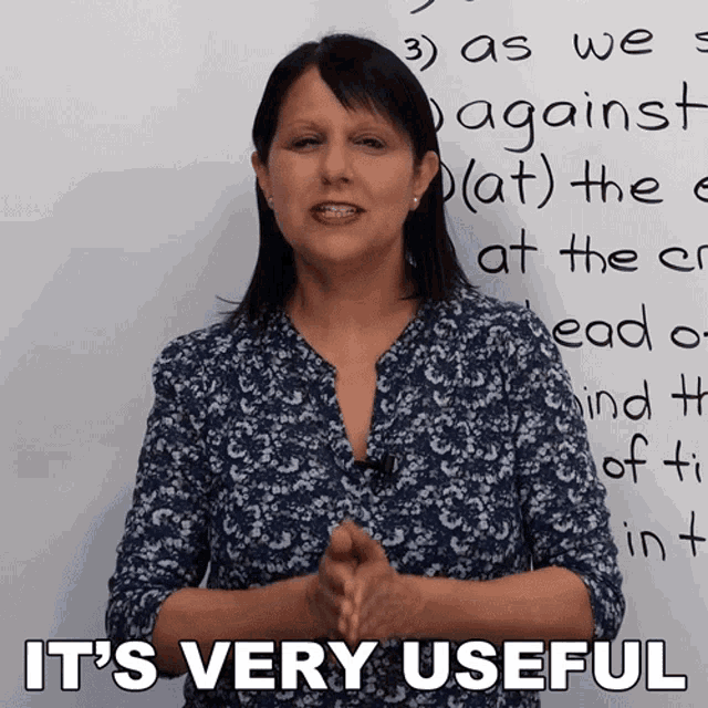a woman stands in front of a white board with the words it 's very useful on it