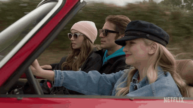three people in a red car with a netflix logo