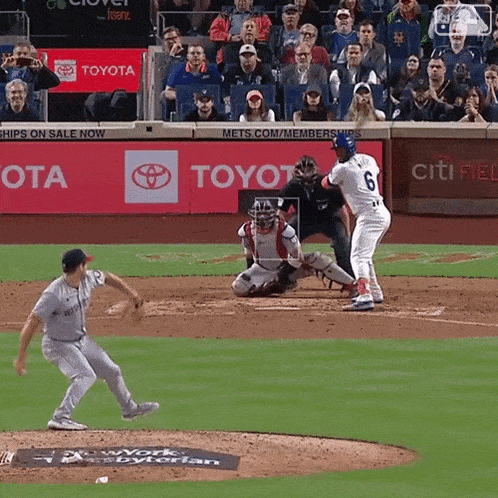 a baseball game is being played in front of a toyota sign