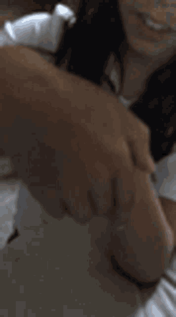 a close up of a person 's hand holding a bottle .