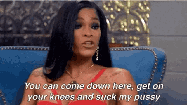 a woman in a red dress is sitting on a blue couch and saying you can come down here .