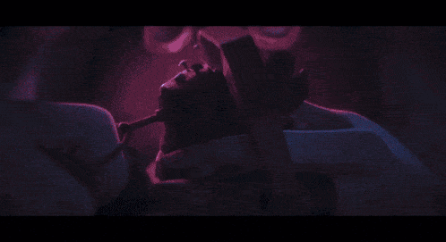 a blurry picture of a person in a dark room with a blue light behind them